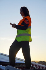 renewable energies. female technician checking installation of vacuum tube solar panels.