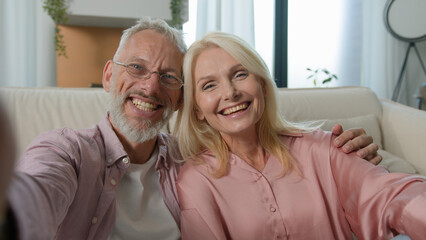 Cheerful Caucasian old senior elderly couple family talking mobile phone gadget man male woman...