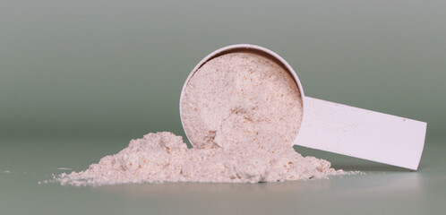 Plastic measuring scoop with protein powder