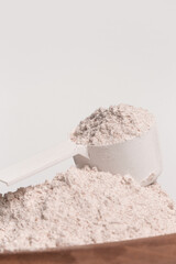 Plastic measuring scoop with protein powder
