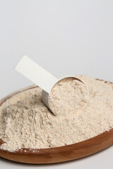 Plastic measuring scoop with protein powder