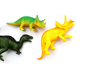 Plastic dinosaur toys on white background