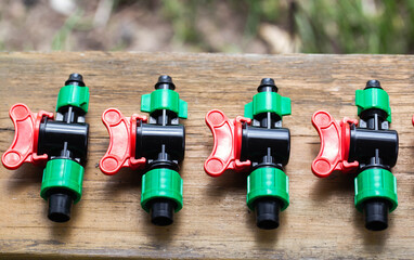 Multicolored plastic taps for assembling drip irrigation at the dacha, close-up