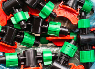 Multicolored plastic taps for assembling drip irrigation at the dacha, close-up