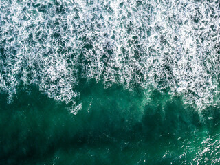 Aerial View of Ocean Waves Hitting Sandy Shore. Aerial drone view. natural background