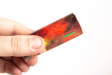 Firecracker with a wick in hand on a white background, isolate, close-up. Copy space for text....