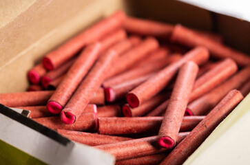 A bunch of firecrackers with red sulfur. Set of pyrotechnics, explosion hazard, macro.