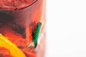 Flying firecracker fireworks with a wick on a white background, close-up, safety precautions. Copy...