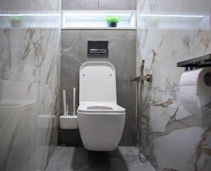 Modern toilet with a wall-hung toilet, porcelain tiles and a shelf with LED lighting