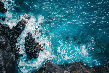 Birds eye view of sharp black volcanic rocks meet