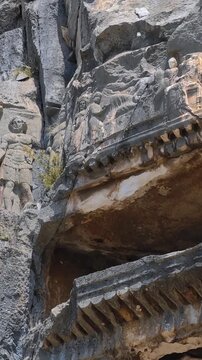 Rock-cut tombs of the ancient Lycian necropolis. Myra is an antique town in Lycia where the small town of Kale (Demre) Turkey.  Close-up of  rock cut tomb grave. 