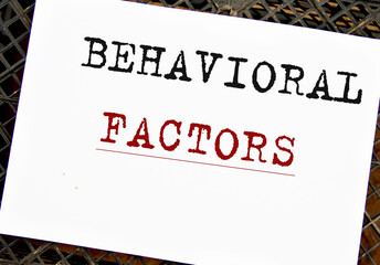 BEHAVIORAL FACTORS - words on white sheet on black grid background