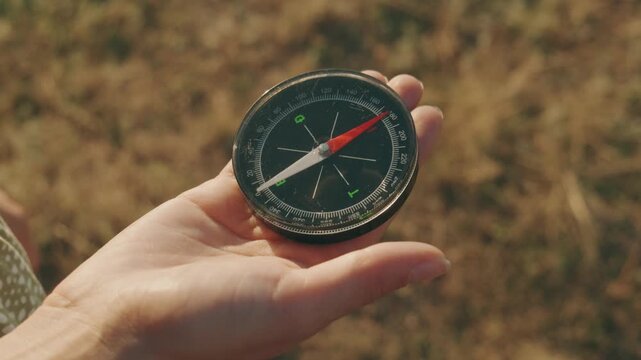 Closeup of a classic compass in hand, perfect for themes of outdoor adventures, travel, and exploration