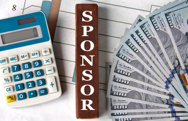 SPONSOR - word on brown wooden blocks on the background of a graph and banknotes