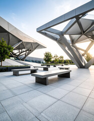 Modern Museum Plaza with Geometric Metal Sculpture and Stone Benches.rust, artwork, contemporary, structure, daytime, geometric, art, clear, daylight, entrance, installation, modern, sun, urban, 