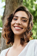 Joyful summer moments with a young woman enjoying nature in the park