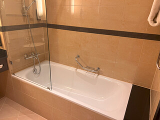 Elegant bathtub in luxury tiled bathroom