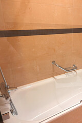 Contemporary bathtub design in tiled bathroom