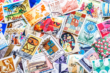 Postage stamps.A collection of world stamps in a pile.Postage stamps from different countries and times