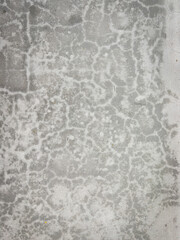 An abstract close-up image of a cement surface with distinct patterns and textures. 