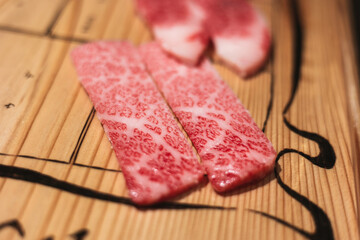 raw beef steak, A5 Wagyu on wooden board, Japanese beef for yakiniku, high quality meat from Japan, BBQ meal in grilling restaurant