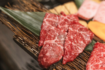 raw beef steak, A5 Wagyu on wooden plate, Japanese beef for yakiniku, high quality meat from Japan, BBQ meal in All-you-can-eat restaurant