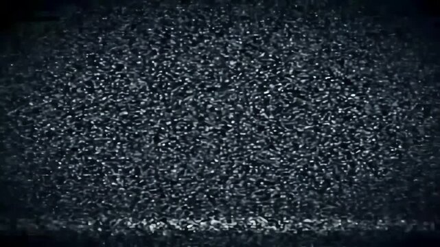 Dark, grainy texture video with intermittent bright lines, suggesting static, disruption, or a damaged signal, symbolizing loss, failure, and absence