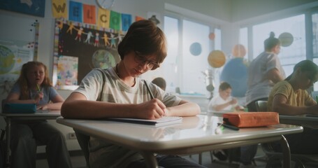 Concentrated Primary School Children Writing School Test on Geography or Ecology in Modern Classroom. Female Teacher Walking Between Desks, Controlling Group of Diverse Kids During the Exam Process.