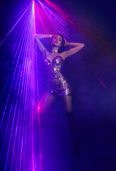 full length photo real person happy woman dancing in dark black room night club ray laser party...