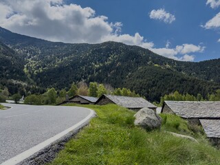 A mountain road with a few houses on it