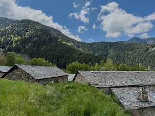 A mountain range with a few houses on the hillside