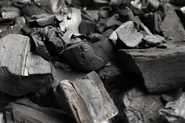 Pieces of black coals as background, closeup