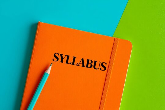 SYLLABUS - word on an orange notepad on a background of multi-colored folders.