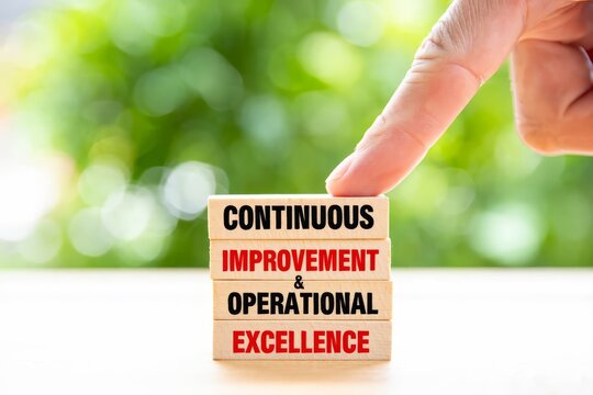 Continuous improvement and operational excellence text on wooden blocks.