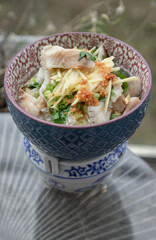 Fish rice porridge or Fish boiled rice (Sea bass fish congee) and Ginger-julienned, Coriander,...