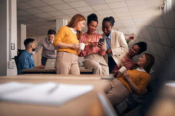 Group of Business Colleagues Socializing and Laughing in Office Setting