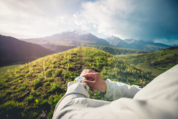 Trail runner set the sports watch running on the high altitude grassland mountain top trail