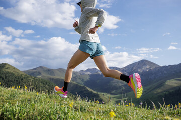 Trail runner set the sports watch  running on the high altitude grassland mountain top trail