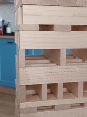 Wooden Stacking Blocks Tower with Blue Kitchen Background