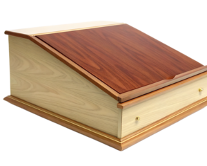 A wooden lectern with a slanted top and a drawer featuring brass knobs on a black background