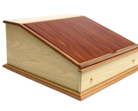 A wooden lectern with a slanted top and a drawer featuring brass knobs on a black background