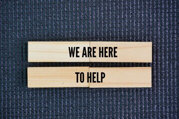 Wood with the words We are here to help. they want to be more to you than a casual friend