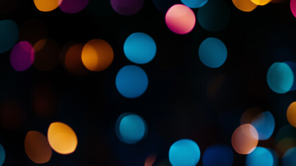 Colorful defocused bokeh lights on dark background for festive mood