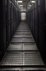 Server room corridor with metal grid floor and cabinets