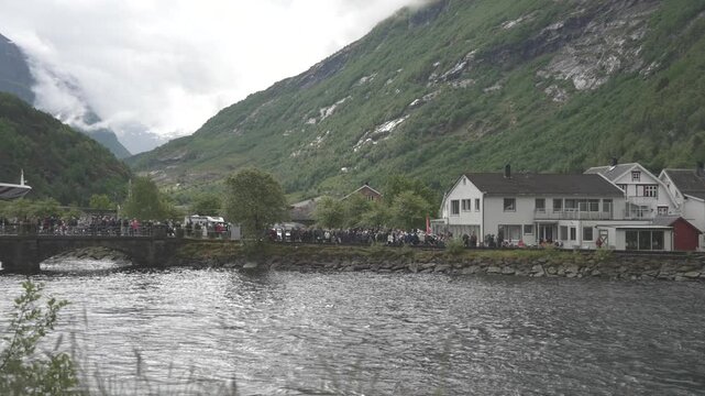 View of cruise ship and visitors on bridge in Hellesylt, Sunnylvsfjorden, Stranda Municipality, Norway, Scandinavia, Europe