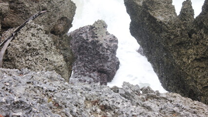 Oceanic Chasm: Gray Volcanic Rocks Frame Turbulent White Water