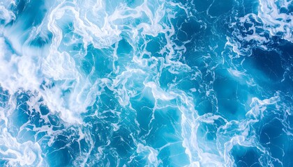 Naklejka premium Aerial view of turquoise ocean water with white foam patterns creating abstract designs