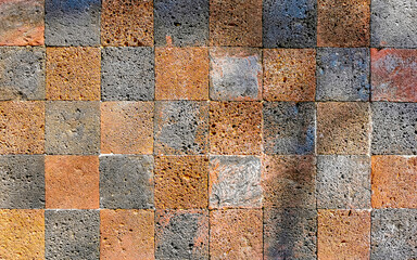 Orange checkerboard pattern wall and floor texture in Mexico.