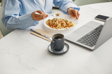 Savoring a scrumptious plate of pasta while simultaneously working on my laptop at a chic and...