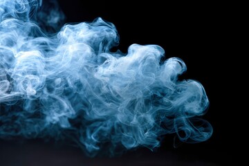 Wispy voluminous cloud of bluetinged smoke against stark black background